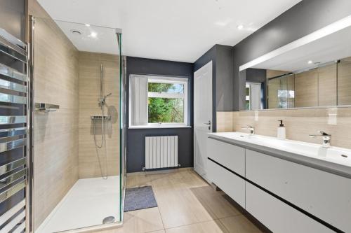 a bathroom with a sink and a shower at Luxury 5 Bedroom with Pool & Games Room in Potter Street