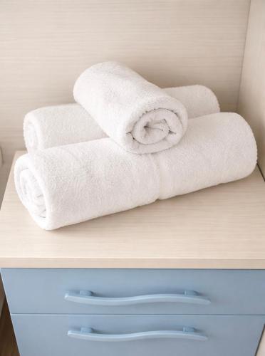 a stack of towels sitting on top of a shelf at Il Gerlo in Lezzeno
