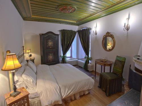 a bedroom with a bed and a table and a mirror at Papigo Towers in Papigko