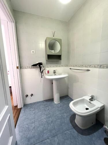 a bathroom with a sink and a toilet at The Llanete Collection 02 in Martos
