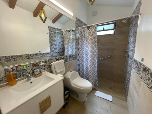 a bathroom with a sink and a toilet and a shower at Hosteria Punta Blanca in Punta Blanca