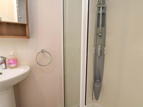 a shower with a glass door in a bathroom at Caravan B14 Beechrise in Filey