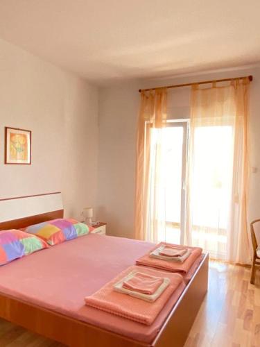 a bedroom with a bed with two towels on it at Mia 6 in Crikvenica