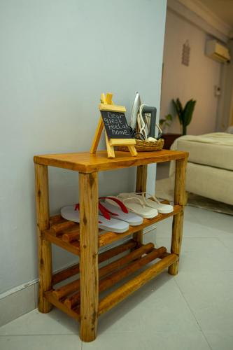 a wooden shelf with shoes on top of it at Nyumbani 2 studio in Dar es Salaam