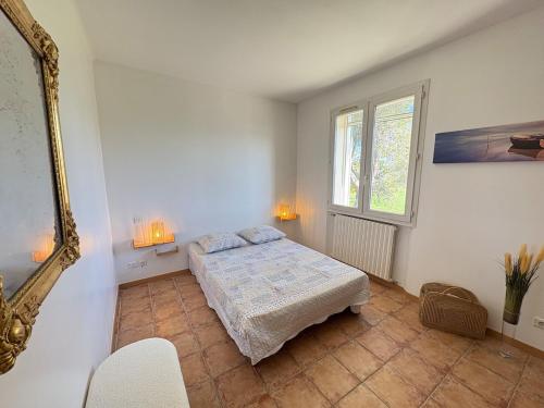 a bedroom with a bed and a mirror at Victoria House pool garden in Fourques