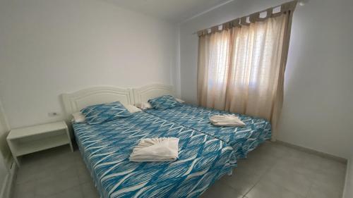 a bedroom with a bed with two towels on it at La Playa 2 A in La Laja