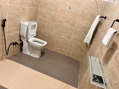 a bathroom with a white toilet in a room at River Side Guest House in Hatton
