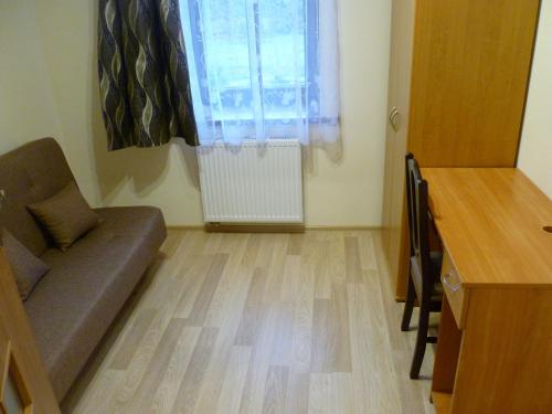a living room with a couch and a window at Energy House in Jasło