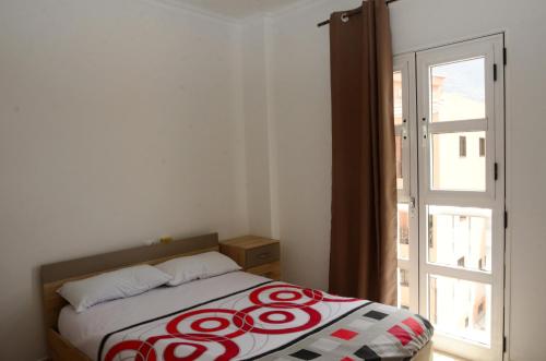 a bed in a room with a window and a door at Paquita in La Laja
