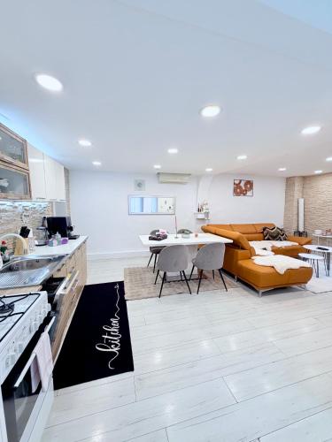 a kitchen and living room with a couch and a table at Alia house with garden in Piešťany in Piešťany