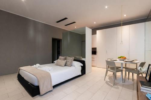 a bedroom with a bed and a table and a dining room at Casa Leon in Mantova