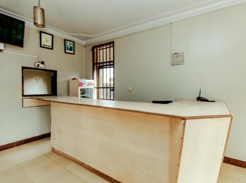 a kitchen with a counter top in a room at Hulcity silver hotel in Kyebando