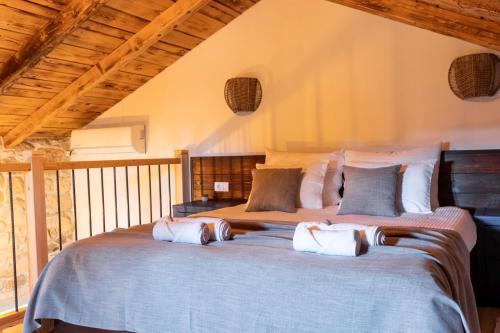 a bedroom with a large bed with pillows at Villa Dvori Jokic in Islam Grčki