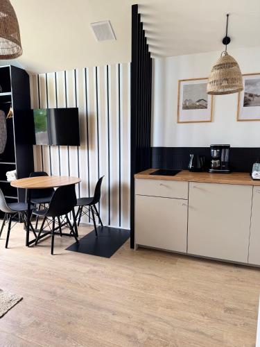 a kitchen and dining room with a table and chairs at ODSKOCZNIA Rewa in Rewa