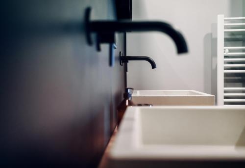 a bathroom with a sink and a faucet at Walser ART in Mittelberg