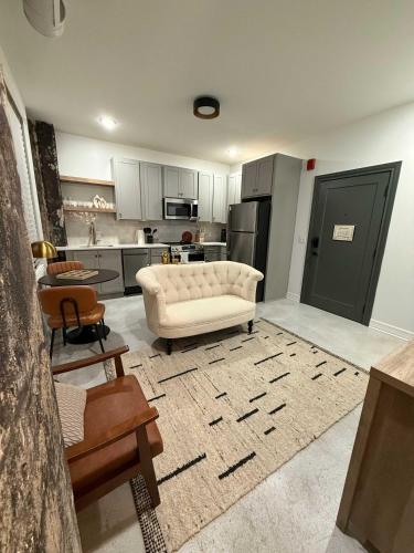 a living room with a white couch and a kitchen at Park Hotel 1BR Suite 210 in Chattanooga