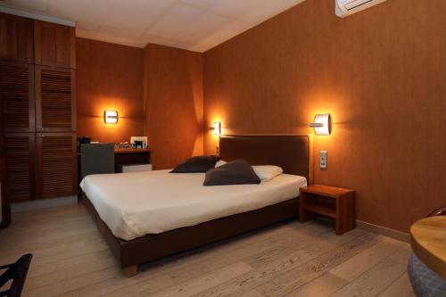 a bedroom with a bed with two pillows on it at Radici in Nieuwpoort