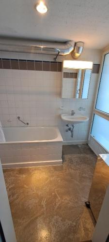 a bathroom with a tub and a sink at Exclusive Loft in Seefeld - Mühle in Zurich
