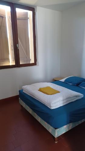 a bed sitting in a room with a window at Bel Appartement Fonctionnel,2 grandes chambres separer plus un bz,WI FI,Clim in Digoin