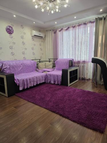 a room with a purple bed and a purple rug at Квартира in Bilhorod-Dnistrovskyi