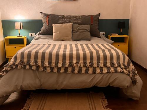 a bedroom with a large bed with two night stands at Casita Eureka in San Antonio de Areco