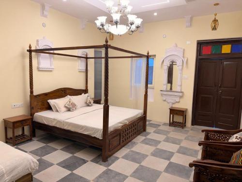 a bedroom with a canopy bed and a checkered floor at Hotel Shekhawati Mandawa in Mandāwa