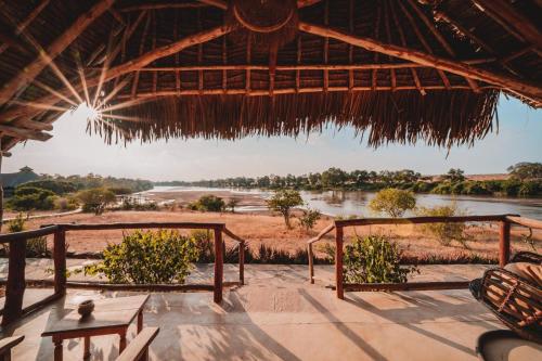 a view of a river from a hut with a view at Kudu Safari Camp in Koito