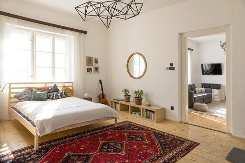a bedroom with a bed and a living room at Villa Old Almond in Balatonalmádi