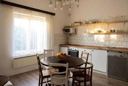 a kitchen with a table and chairs and a kitchen with a window at Villa Old Almond in Balatonalmádi