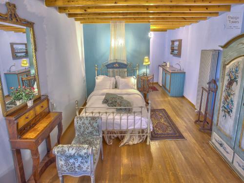 a bedroom with a bed and a table and a mirror at Papigo Towers in Papigko
