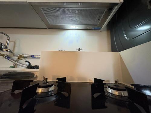 a kitchen with a stove top in a room at Stay GaeBong in Seoul