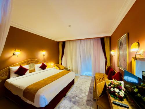 a hotel room with a bed and a television at Oriental Rivoli Hotel & Spa in Sharm El Sheikh