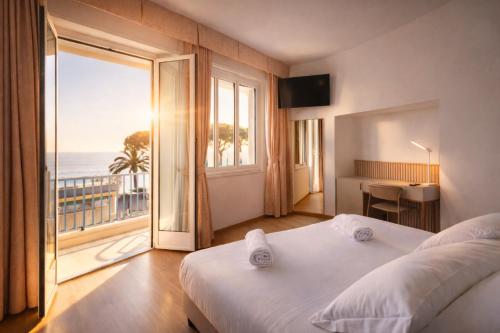 a bedroom with a bed and a view of the ocean at LVG Hotel Collection - Majestic in Alassio