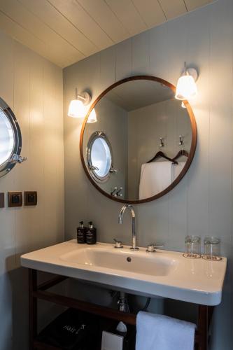 a bathroom with a sink and a mirror at Relais de Chambord, a Small Luxury Hotels of the World in Chambord