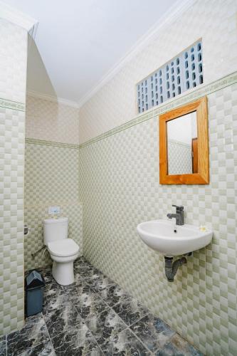 a bathroom with a sink and a toilet at Kayuma House Canggu in Canggu