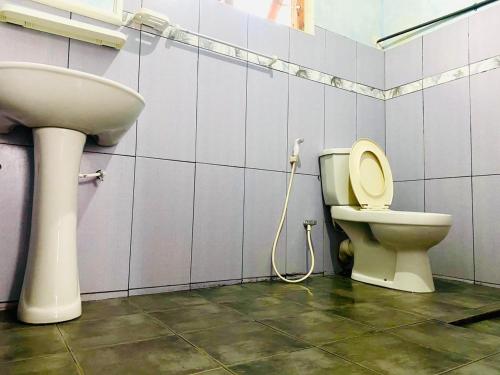 a bathroom with a toilet and a sink at Siloneeds HOSTEL in Nuwara Eliya