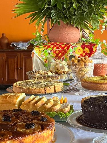 a table topped with lots of different types of bread at Pousada Taba de Canes in Canavieiras