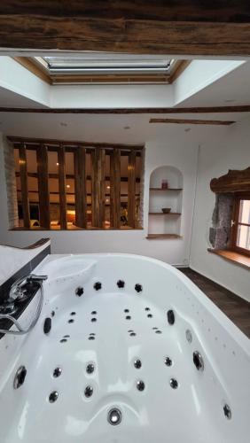 a bath tub with black rocks in a room at Loft Unique Romantique & Balnéothérapie in Riom