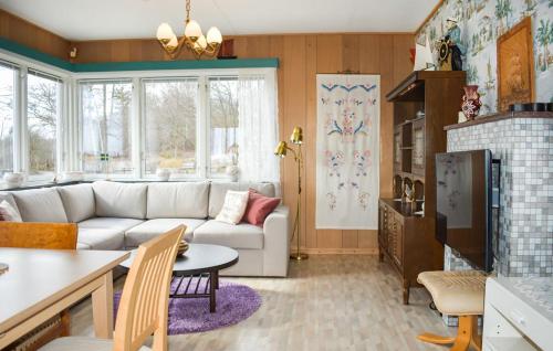 a living room with a couch and a table at Sommarstuga med strandtomt in Ronneby