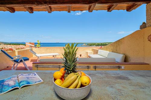 a bowl of fruit on a table with a view of the beach at Marineledda la terrazza sul golfo in Santa Marinella