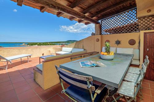 a table and chairs on a patio with a view of the ocean at Marineledda la terrazza sul golfo in Santa Marinella