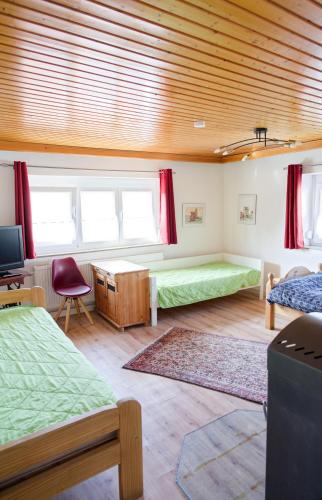 a room with two beds and a desk in it at Monteurwohnung bei Crailsheim Feuchtwangen in Fichtenau