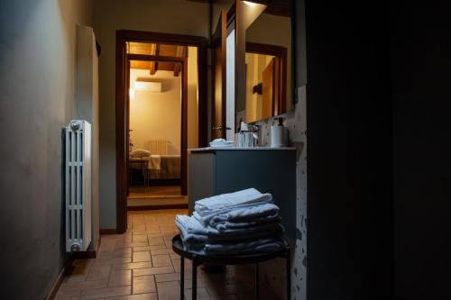 a kitchen with a counter with towels on a stool at Casa Gotica in Castelfranco Emilia