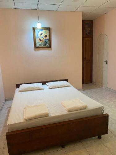 a bedroom with a bed with two towels on it at SAMA TOURIST guest in Seeduwa