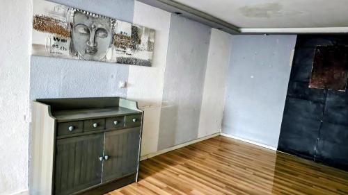 a room with a cabinet and a painting on the wall at Monteurzimmer Nähe Pforzheim in Engelsbrand