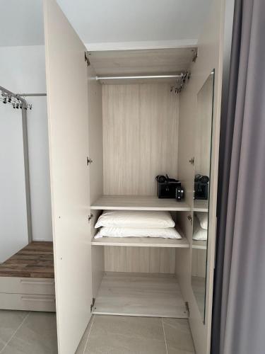 a white closet with a bed and a mirror at Acquaviva Suites, Pool - View in San Vincenzo