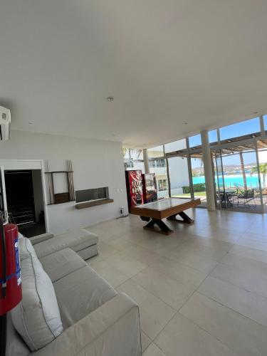 a living room with a couch and a table at Bluu Habitat Lagoons 206 in Mazatlán