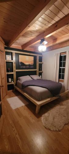 a bedroom with a large bed in a room at Ohana cabin in Hanover