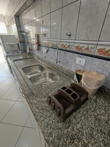 a kitchen with a sink and a counter top at Bacacheri 5 Estrelas in Curitiba