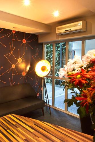a living room with a couch and a large window at Town Hotel Wiesbaden - kleines Privathotel in Bestlage in Wiesbaden